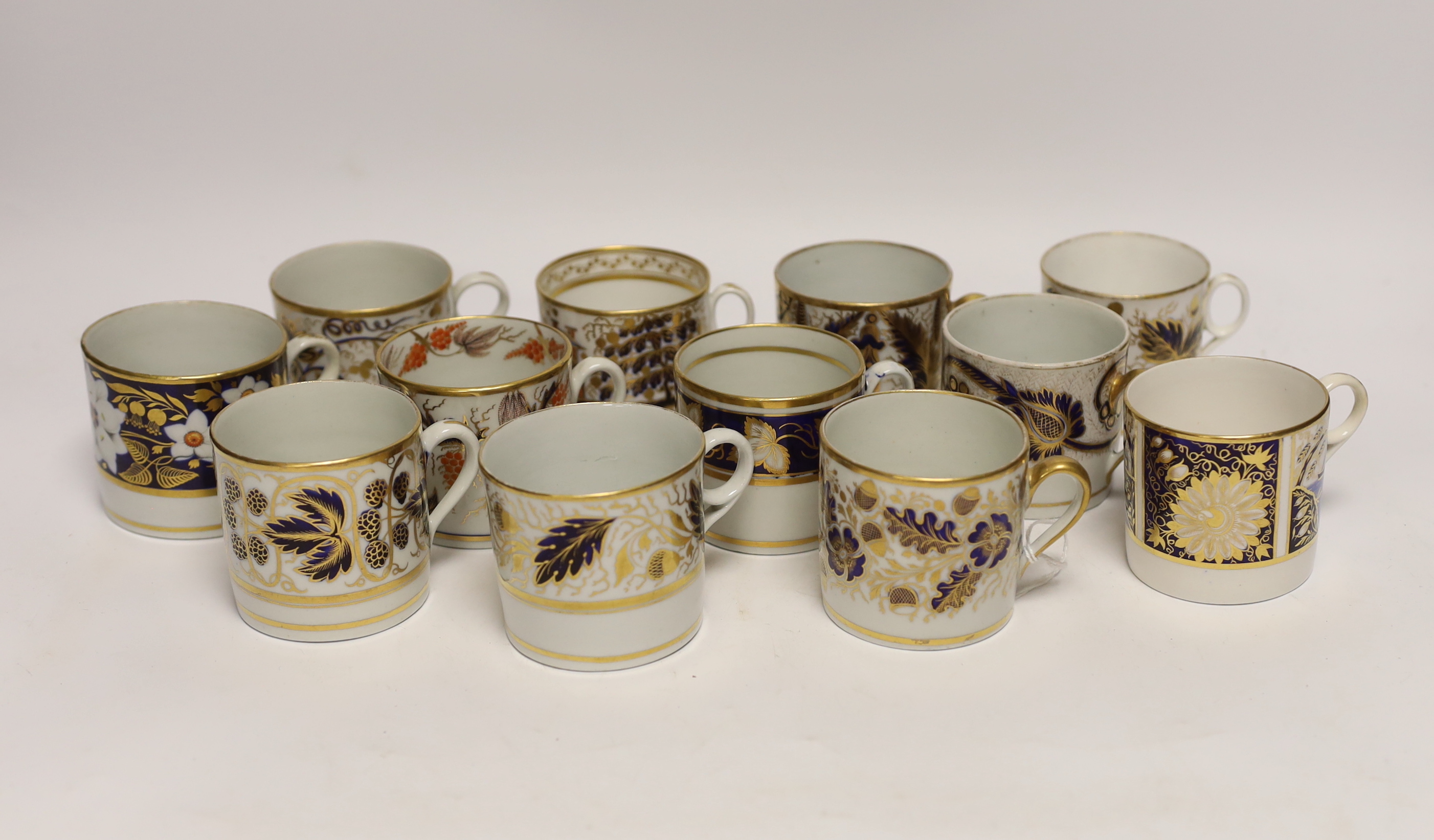 Twelve 1800-1820 English porcelain, mostly blue and gilt decorated coffee cans